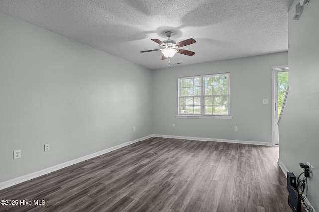 202 Courtyard W, Newport, NC 28570 - spare room featuring plenty of natural light, dark wood finished floors, a ceiling fan, and a textured ceiling