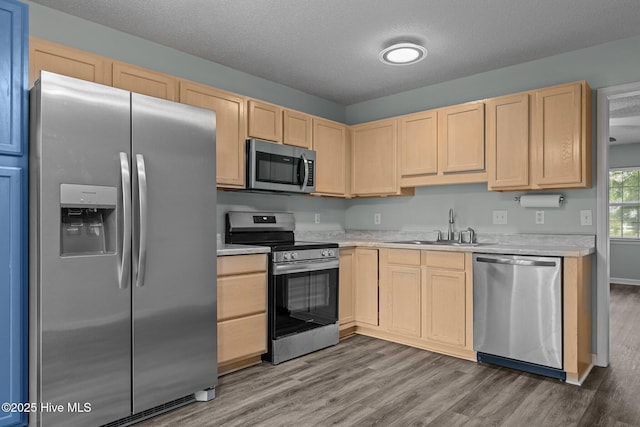 202 Courtyard W, Newport, NC 28570 - kitchen with stainless steel appliances, light brown cabinets, light countertops, wood finished floors, and a textured ceiling