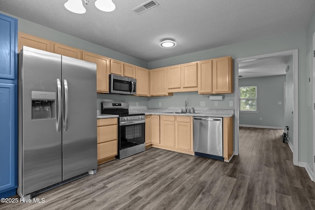 202 Courtyard W, Newport, NC 28570 - kitchen featuring stainless steel appliances, light brown cabinets, light countertops, and a textured ceiling