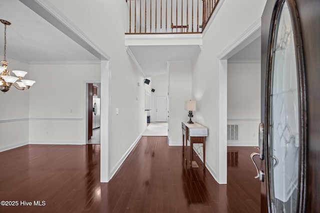 3107 Indian Wells Pl, Greenville, NC 27858 - foyer entrance featuring a chandelier, wood finished floors, a high ceiling, baseboards, and crown molding