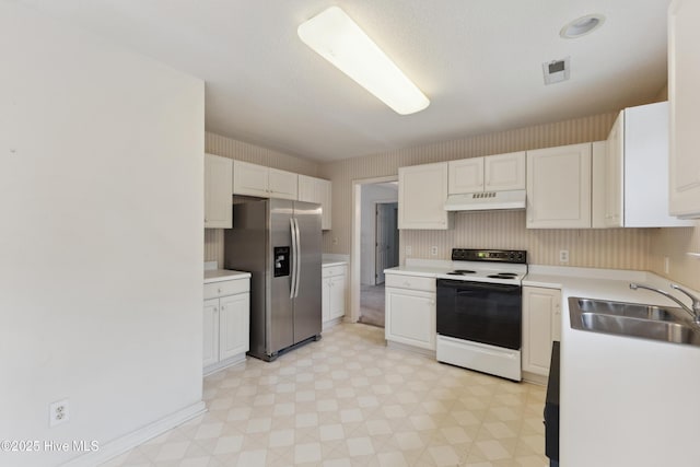 6814 Lipscomb Dr, Wilmington, NC 28412 - kitchen featuring stainless steel refrigerator with ice dispenser, electric range oven, under cabinet range hood, a sink, and light floors