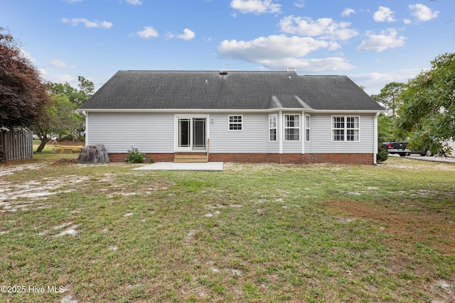 6814 Lipscomb Dr, Wilmington, NC 28412 - rear view of property featuring entry steps, a lawn, a patio area, and a shingled roof