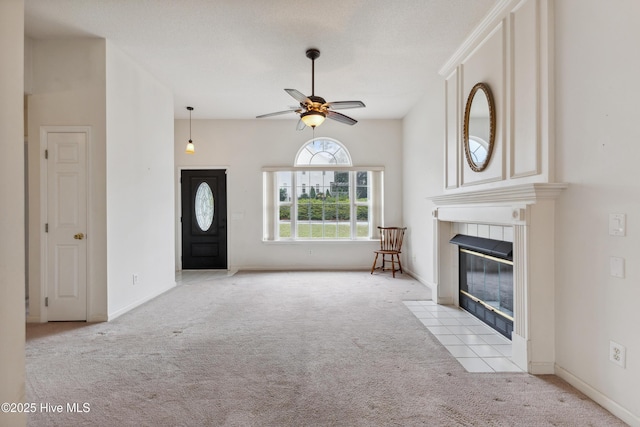 6814 Lipscomb Dr, Wilmington, NC 28412 - unfurnished living room featuring carpet, ceiling fan, a tile fireplace, and baseboards