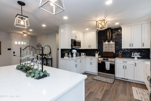 103 Midway Ln, Roanoke Rapids, NC 27870 - kitchen featuring appliances with stainless steel finishes, wall chimney range hood, tasteful backsplash, light countertops, and white cabinetry