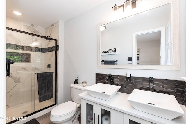 103 Midway Ln, Roanoke Rapids, NC 27870 - full bathroom with a stall shower, double vanity, toilet, and decorative backsplash