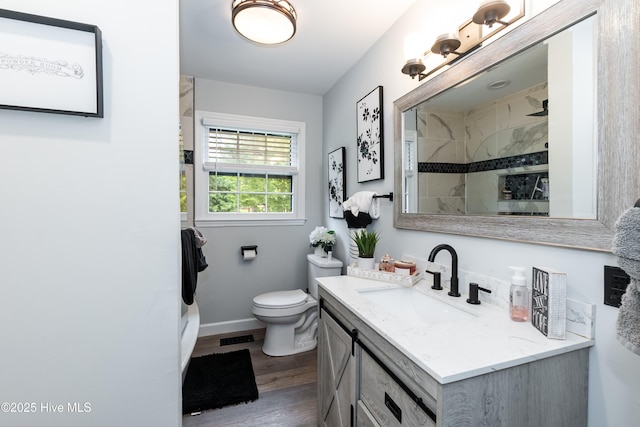 103 Midway Ln, Roanoke Rapids, NC 27870 - full bath with vanity, baseboards, wood finished floors, toilet, and tiled shower
