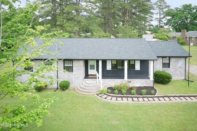 103 Midway Ln, Roanoke Rapids, NC 27870 - ranch-style home featuring a shingled roof, a front yard, covered porch, and brick siding