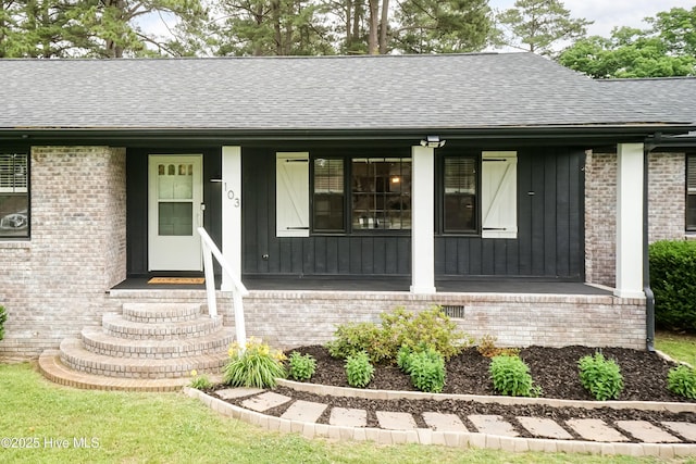 103 Midway Ln, Roanoke Rapids, NC 27870 - view of front of house featuring covered porch, roof with shingles, and brick siding