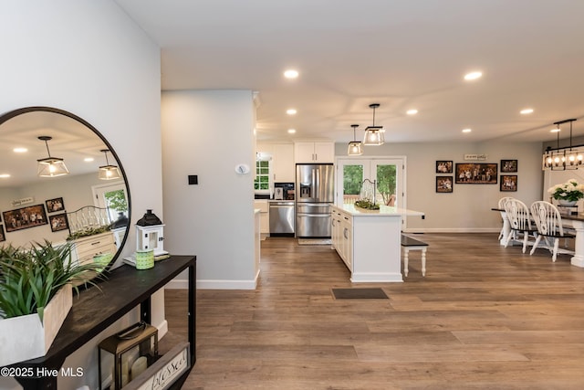 103 Midway Ln, Roanoke Rapids, NC 27870 - kitchen featuring stainless steel appliances, recessed lighting, white cabinets, light countertops, and healthy amount of natural light