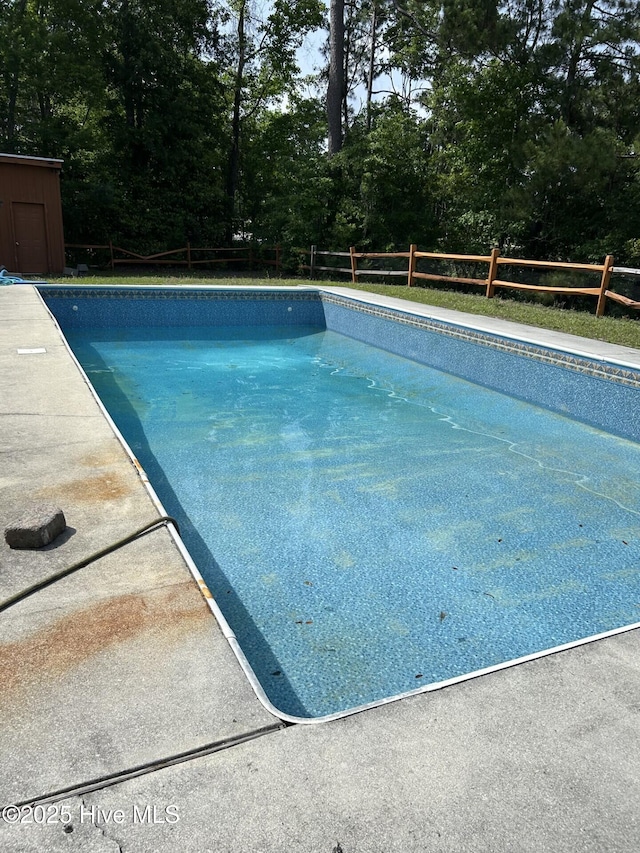 106 Eagle Ln, Hampstead, NC 28443 - swimming pool with a fenced backyard and view of wooded area