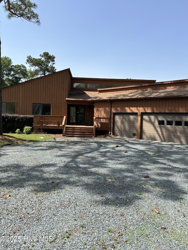 106 Eagle Ln, Hampstead, NC 28443 - view of front of home with an attached garage, a deck, and gravel driveway