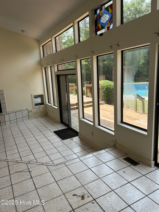 106 Eagle Ln, Hampstead, NC 28443 - doorway with tile patterned floors and a towering ceiling
