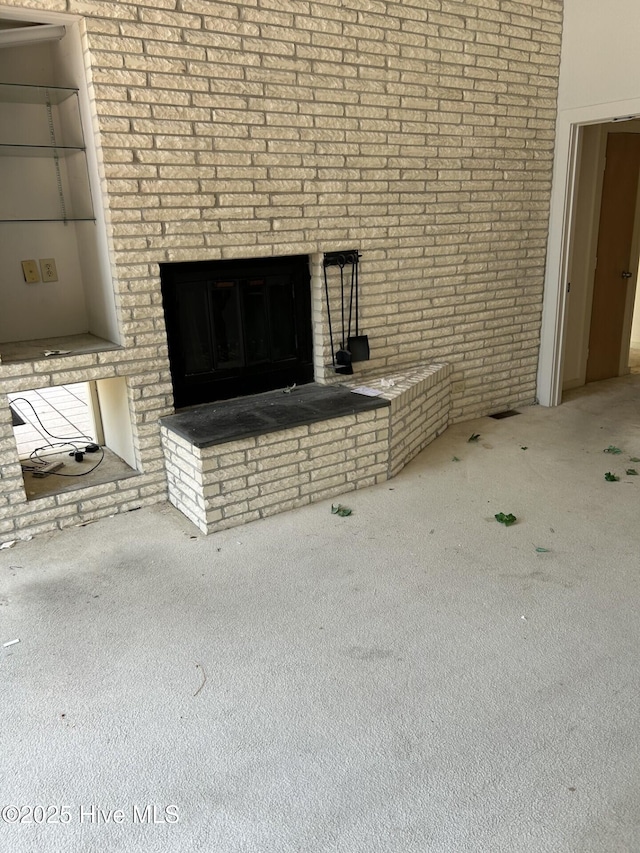 106 Eagle Ln, Hampstead, NC 28443 - detailed view of carpet flooring, a fireplace, and brick wall