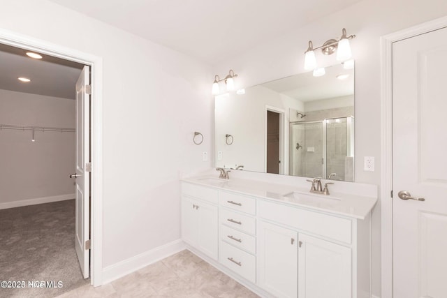 2986 Lyndhurst Ter SW, Shallotte, NC 28470 - bathroom with a walk in closet, a stall shower, double vanity, baseboards, and recessed lighting