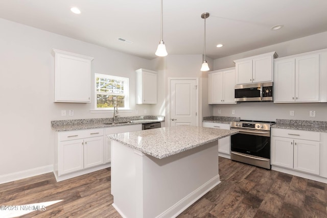 2986 Lyndhurst Ter SW, Shallotte, NC 28470 - kitchen featuring stainless steel appliances, a sink, white cabinets, dark wood-type flooring, and recessed lighting