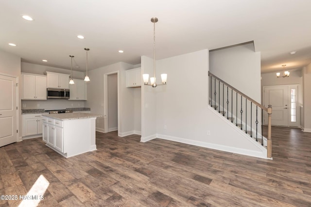 2986 Lyndhurst Ter SW, Shallotte, NC 28470 - kitchen featuring a chandelier, stainless steel microwave, dark wood-style flooring, and recessed lighting