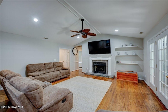 547 Deer Run Rd, New Bern, NC 28562 - living room with a ceiling fan, wood finished floors, a fireplace with raised hearth, vaulted ceiling, and baseboards