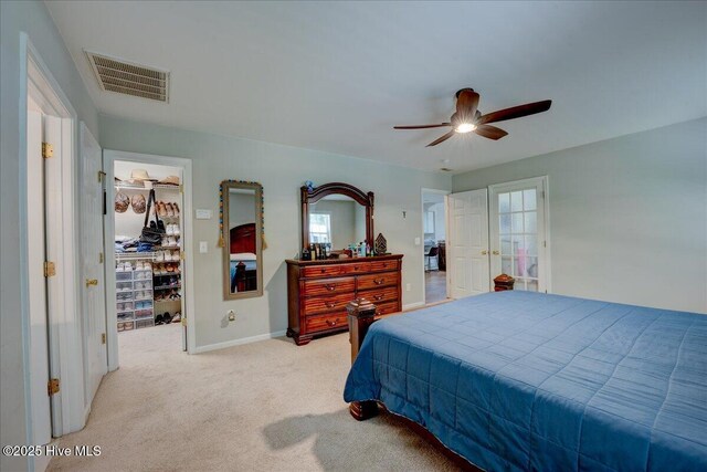 547 Deer Run Rd, New Bern, NC 28562 - bedroom featuring a spacious closet, light colored carpet, multiple windows, and baseboards