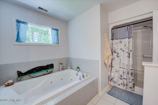 547 Deer Run Rd, New Bern, NC 28562 - bathroom featuring a jetted tub, a shower with shower curtain, tile patterned floors, and baseboards
