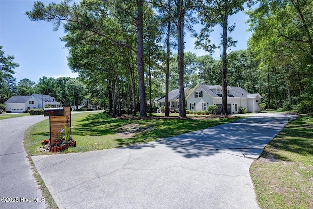 547 Deer Run Rd, New Bern, NC 28562 - view of front of property with driveway, a front lawn, an attached garage, and view of wooded area