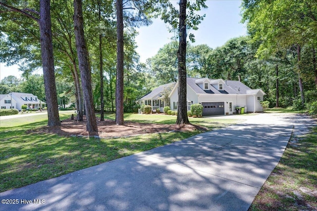 547 Deer Run Rd, New Bern, NC 28562 - view of front of house with driveway, a front yard, an attached garage, and view of wooded area