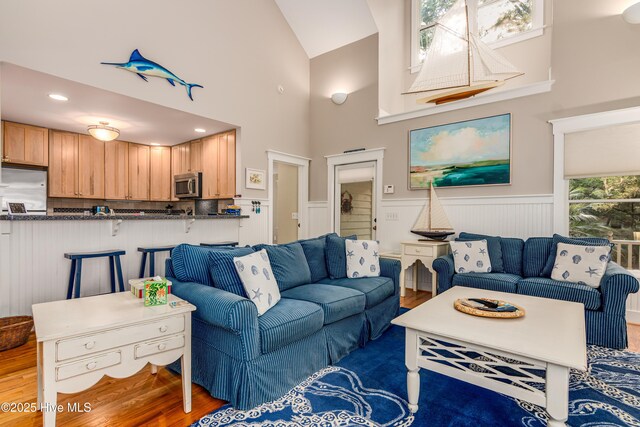 20 Fort Holmes Trl, Bald Head Island, NC 28461 - living area featuring wood finished floors, a wainscoted wall, and high vaulted ceiling