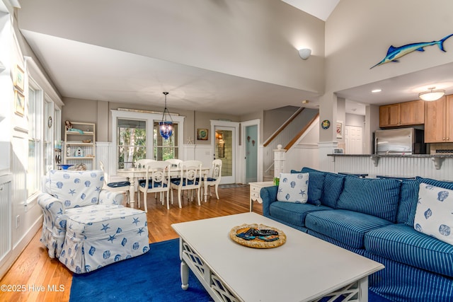 20 Fort Holmes Trl, Bald Head Island, NC 28461 - living room featuring light wood-type flooring, stairway, wainscoting, and a decorative wall