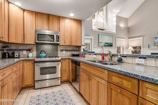 20 Fort Holmes Trl, Bald Head Island, NC 28461 - kitchen featuring stainless steel appliances, a sink, light tile patterned floors, decorative backsplash, and stone counters