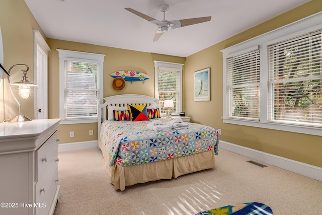 20 Fort Holmes Trl, Bald Head Island, NC 28461 - bedroom with light carpet, baseboards, and ceiling fan
