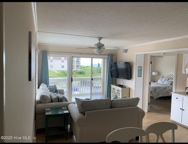 1904 E Fort Macon Rd Unit 269, Atlantic Beach, NC 28512 - living room featuring a textured ceiling, ornamental molding, ceiling fan, and light wood-style floors