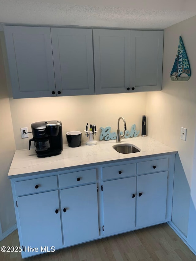1904 E Fort Macon Rd Unit 269, Atlantic Beach, NC 28512 - kitchen with a sink, blue cabinets, light countertops, and a textured ceiling