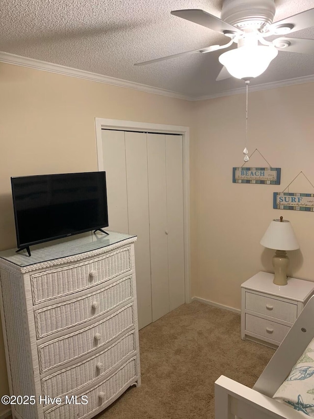 1904 E Fort Macon Rd Unit 269, Atlantic Beach, NC 28512 - bedroom with a closet, carpet flooring, ornamental molding, a ceiling fan, and a textured ceiling