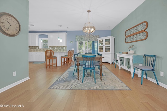 409 Womble St, Oak Island, NC 28465 - dining area with light wood finished floors, a chandelier, and baseboards