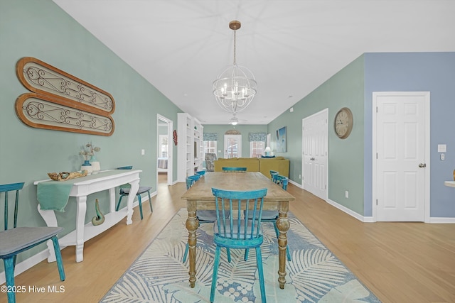 409 Womble St, Oak Island, NC 28465 - dining area featuring a chandelier, wood finished floors, and baseboards