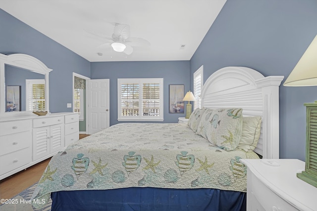 409 Womble St, Oak Island, NC 28465 - bedroom with wood finished floors and a ceiling fan