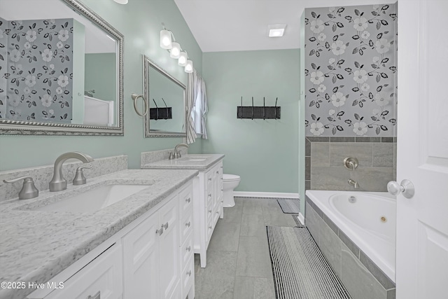 409 Womble St, Oak Island, NC 28465 - full bath with a tub with jets, two vanities, and toilet