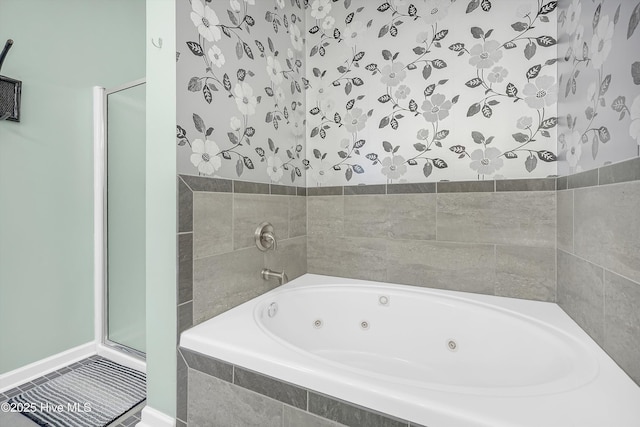 409 Womble St, Oak Island, NC 28465 - bathroom with a tub with jets, a shower stall, and baseboards