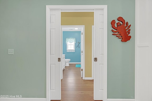 409 Womble St, Oak Island, NC 28465 - corridor with baseboards and hardwood / wood-style flooring