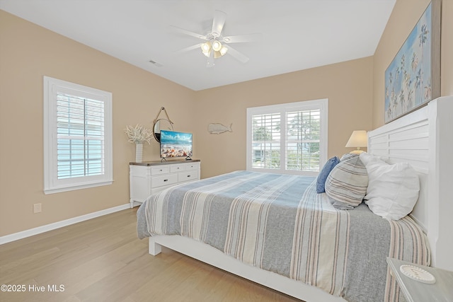 409 Womble St, Oak Island, NC 28465 - bedroom featuring light wood finished floors, baseboards, and ceiling fan
