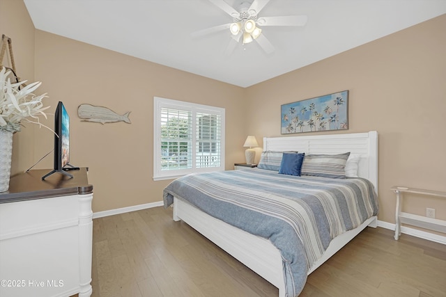 409 Womble St, Oak Island, NC 28465 - bedroom with light wood finished floors, baseboards, and a ceiling fan