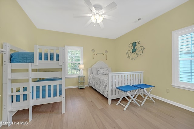 409 Womble St, Oak Island, NC 28465 - bedroom with wood finished floors, multiple windows, baseboards, and ceiling fan