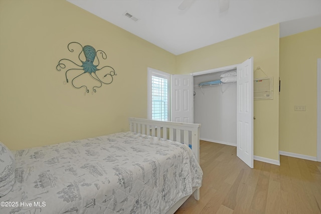 409 Womble St, Oak Island, NC 28465 - bedroom featuring wood finished floors, a closet, baseboards, and ceiling fan