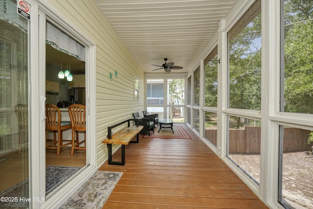 409 Womble St, Oak Island, NC 28465 - sunroom with wood-type flooring, ceiling fan, and wooden walls