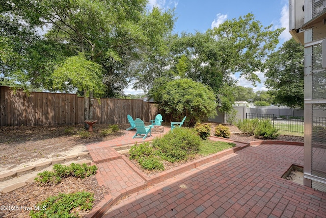 409 Womble St, Oak Island, NC 28465 - fenced backyard featuring a fire pit and a patio area