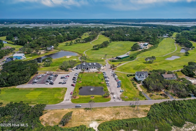 409 Womble St, Oak Island, NC 28465 - aerial view of property's location featuring a nearby body of water, a golf course, and a tree filled landscape