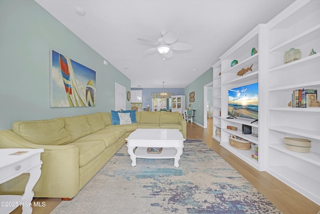 409 Womble St, Oak Island, NC 28465 - living area featuring ceiling fan, wood finished floors, a chandelier, and built in features
