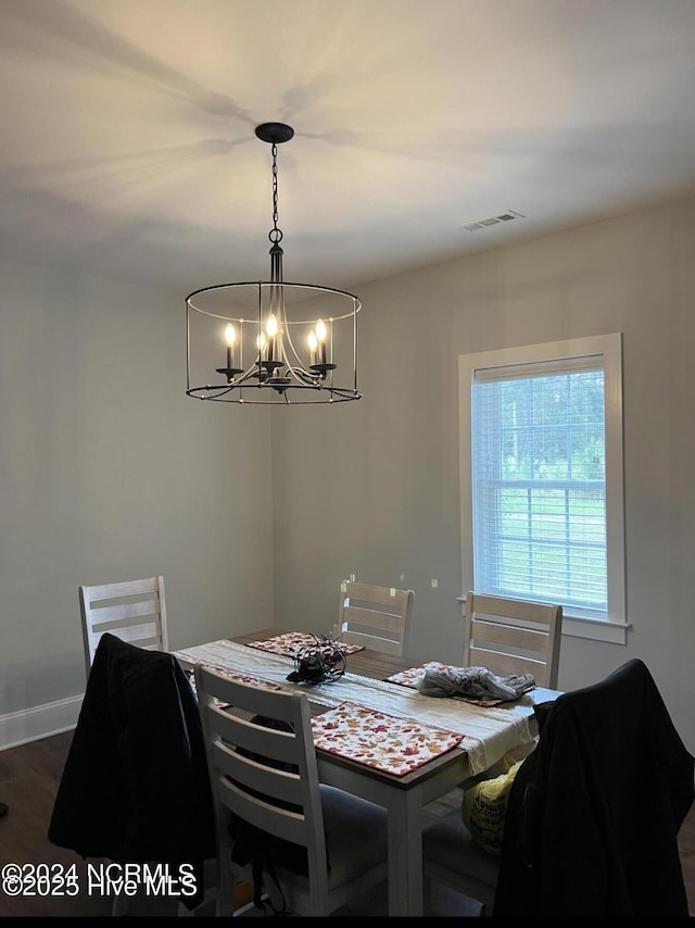 622 Williams St, Enfield, NC 27823 - dining room with a chandelier, dark wood-style flooring, and baseboards