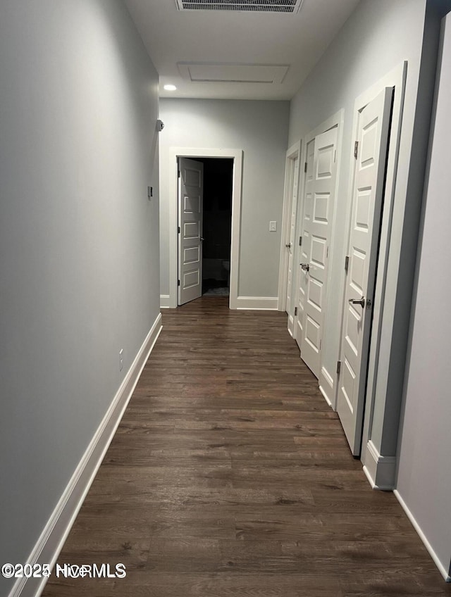 622 Williams St, Enfield, NC 27823 - hall featuring dark wood-style flooring, attic access, and baseboards