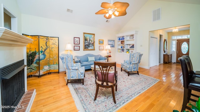 777 Marsh Rose Path NW, Calabash, NC 28467 - living room with a multi sided fireplace, a ceiling fan, light wood finished floors, and high vaulted ceiling