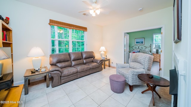 777 Marsh Rose Path NW, Calabash, NC 28467 - living room featuring a ceiling fan, a fireplace, baseboards, and light tile patterned floors